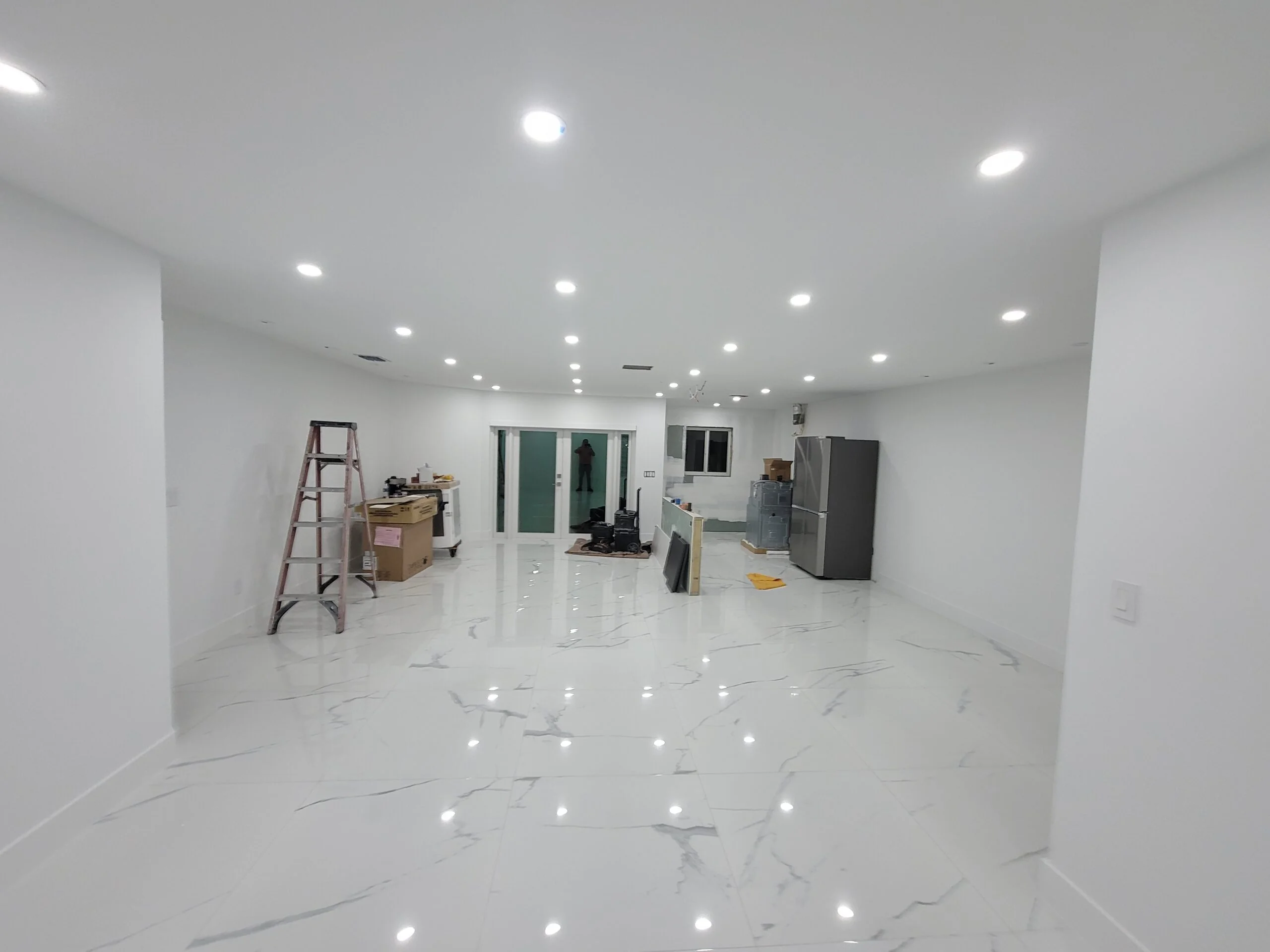 Remodeled interior with glossy white marble floor and LED lighting, Miami, FL